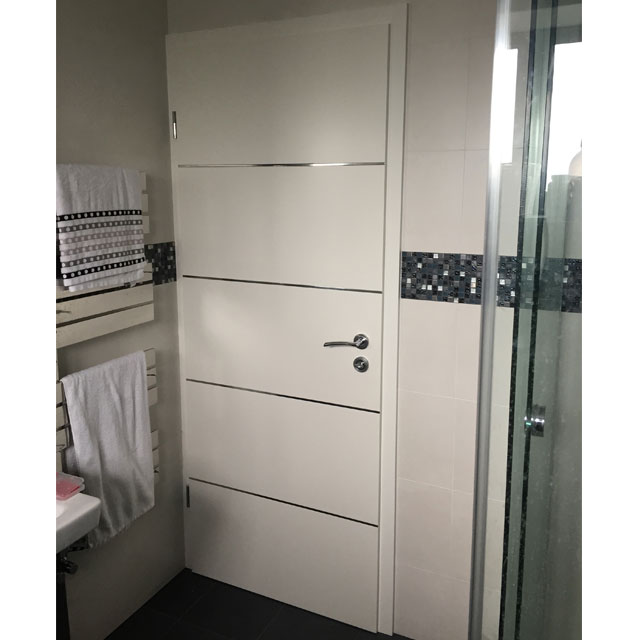 white bathroom door with designs
